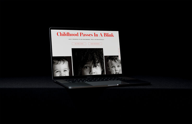 Laptop displaying the words "childhood passes in a blink" alongside an image of heirloom child photos.