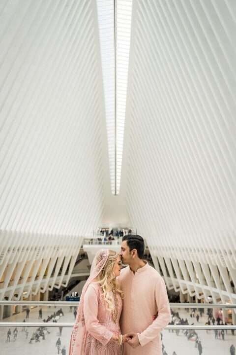 Bride and groom share a kiss at sweetheart table with floral centerpiece and their dog beside them – captured by Alex Kaplan, NJ wedding