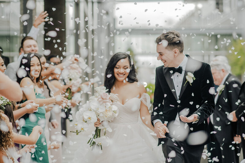 Bride and Groom walk hand in hand at The Omaha Barn, a wedding venue in omaha nebraska. Photo by Nebraska wedding photographer, Anna Brace