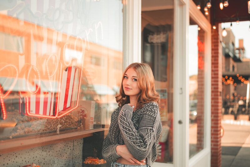 Stylish senior portrait of a student posing against a brick wall in downtown Minneapolis