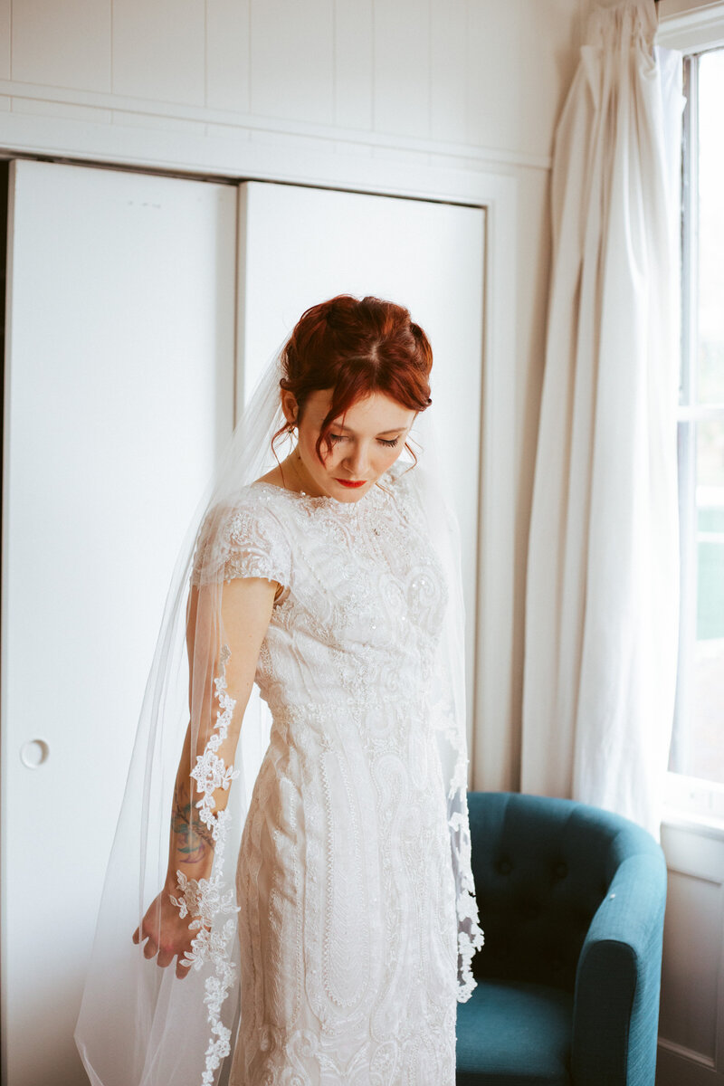 bride admiring her white dress