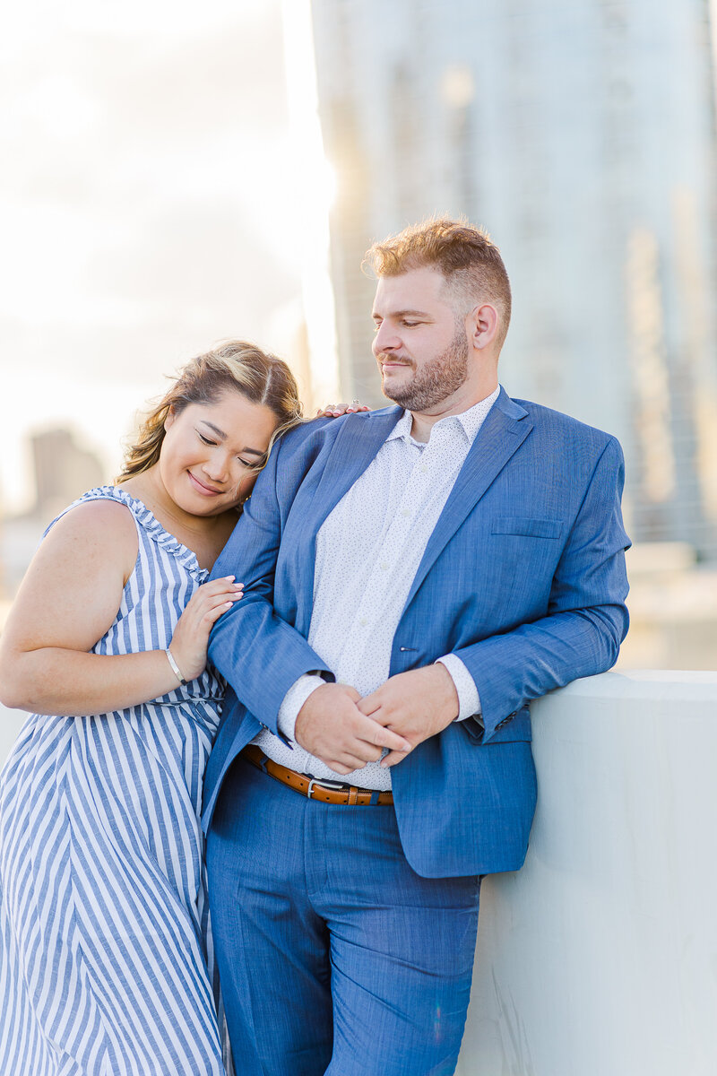 couple wearing blue snuggling on the rootop of a parking garage in honolulu