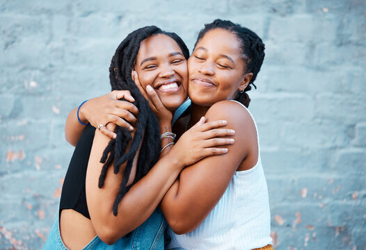 Two Black girls hugging and embracing