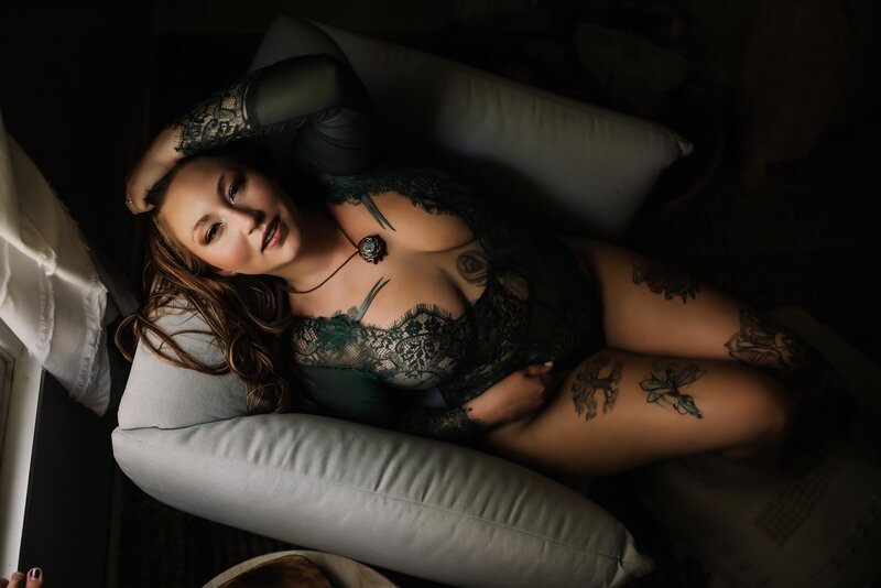 New York City Boudoir Portrait of a woman with tattoos in a sheer black bodysuit