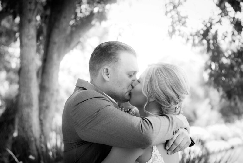 Weddings in Newport Beach bride and groom kissing in black and white photo