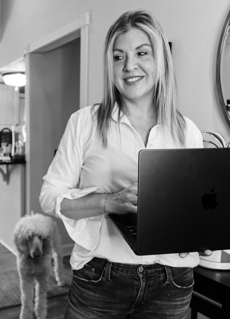 Amy hailstone with laptop computer and golden doodle.
