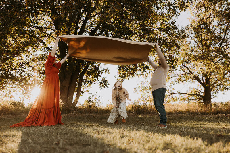 Family of four dressed in nice clothes walks through a Wisconsin field.