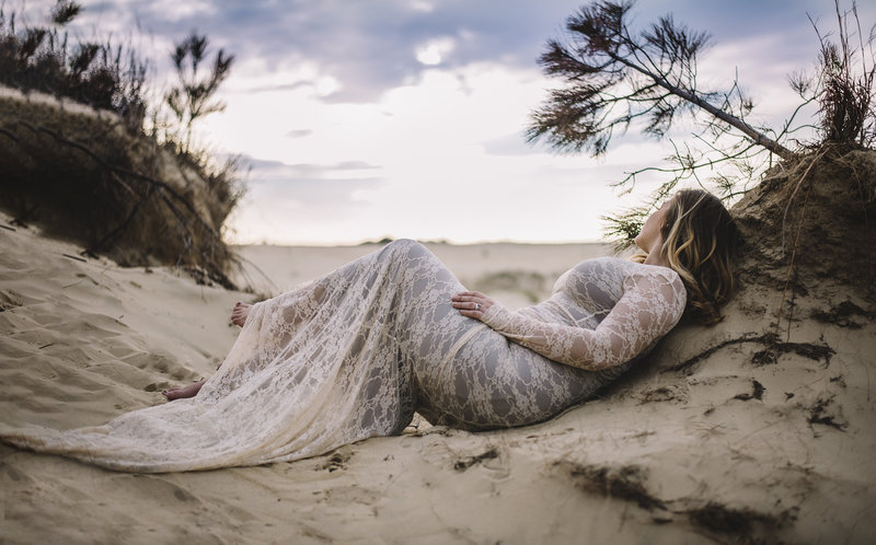 bride laying on beach in wedding dress