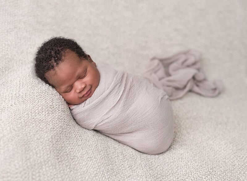 Smiling newborn photo by Houston photographer