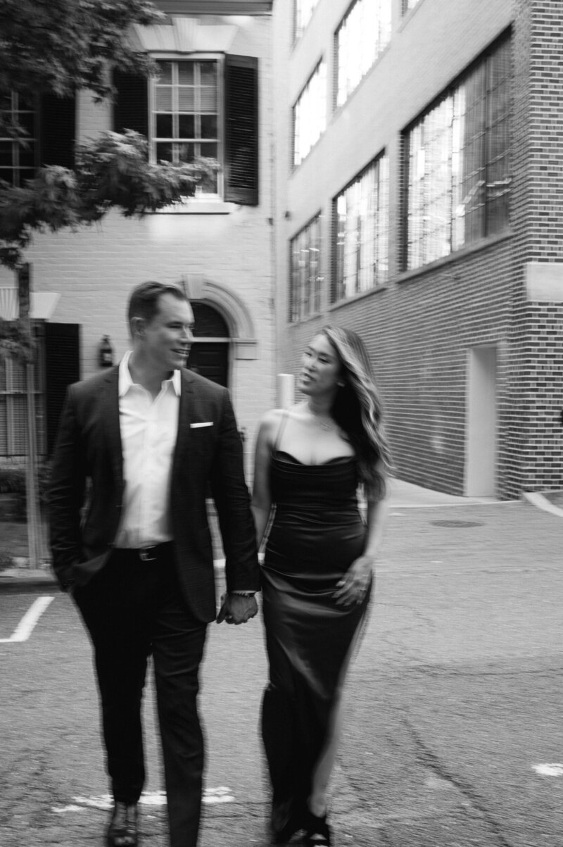 interracial couple blurry photographed in black and white walking around Georgetown Washington DC engagement session
