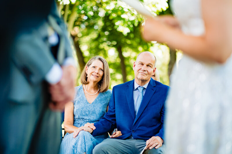 A father and mother cry and hold hands as they watch their child get married in Toledo Ohio