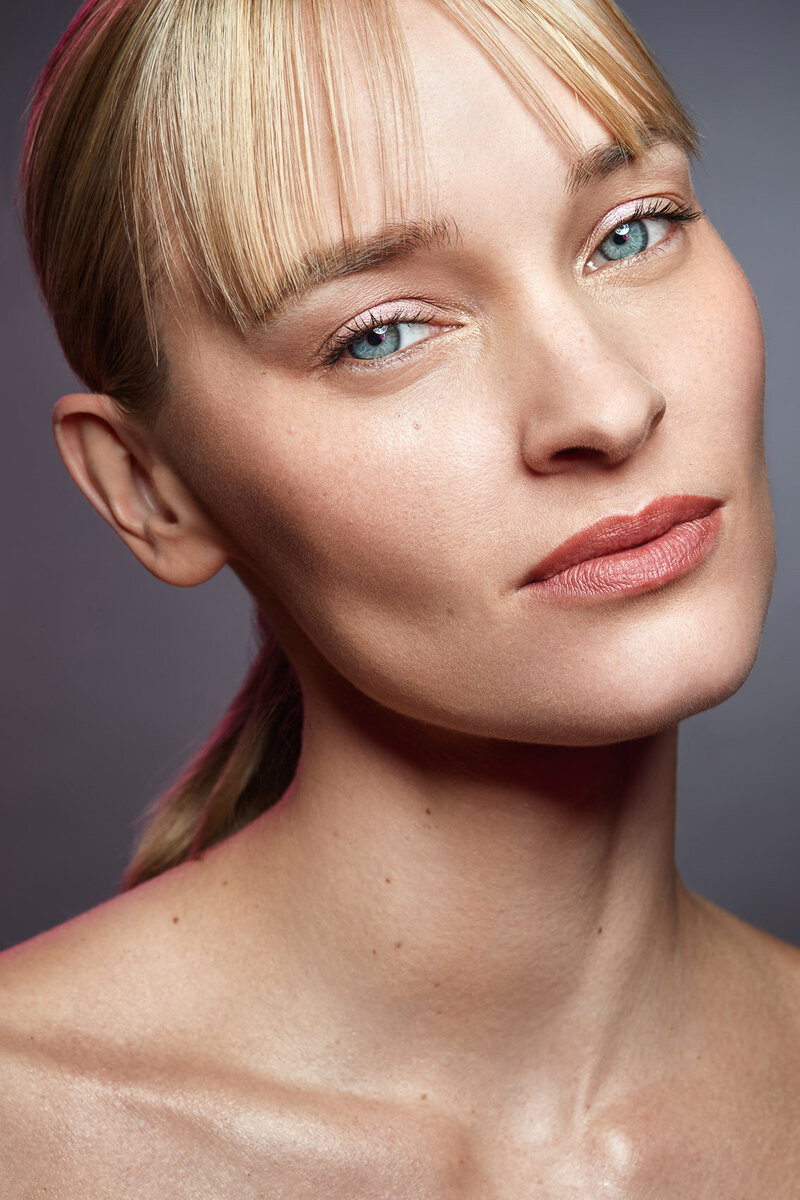 Pernilla in a refined portrait, featuring a subtle smile and natural elegance, shot by Ylva Erevall.