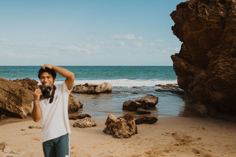 Delcynn holding his camera and smiling