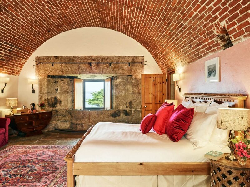 A large fort bedroom with a view of the sea.