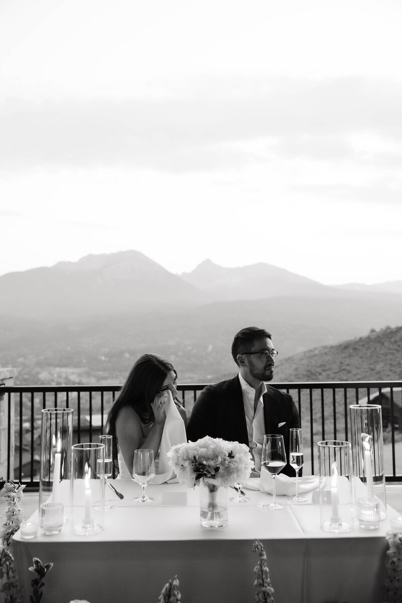 bride tearing up during their dinner party reception at their intimate wedding in Colorado