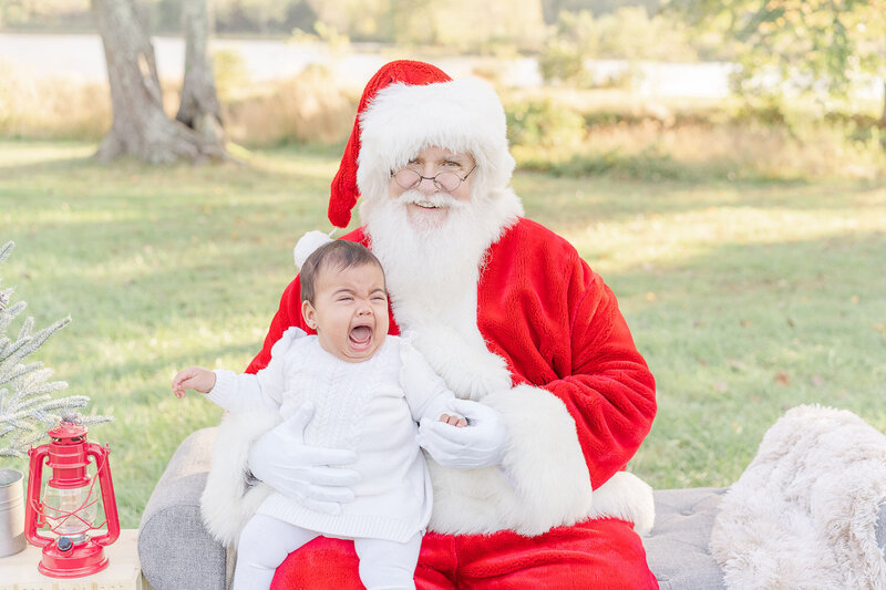 baby crying on santa's lap taken by Northern Va Christmas minis photographer