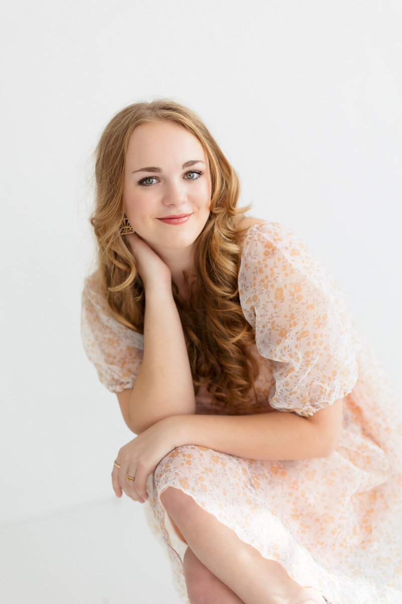 senior girl sitting in Boise photography studio during senior pictures with Tiffany Hix