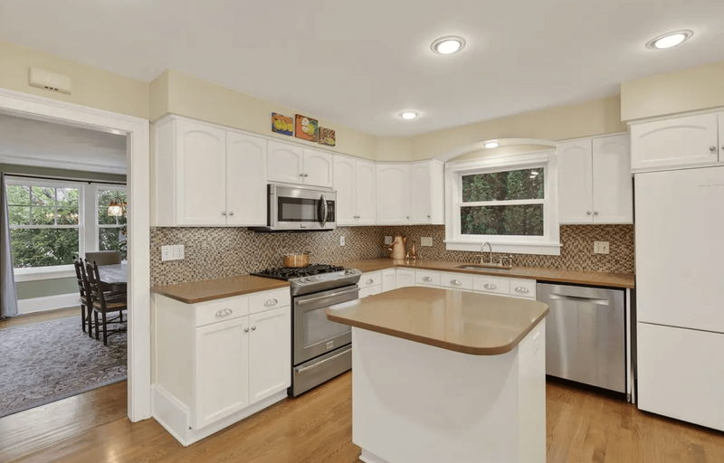A kitchen featuring white cabinets and modern appliances.