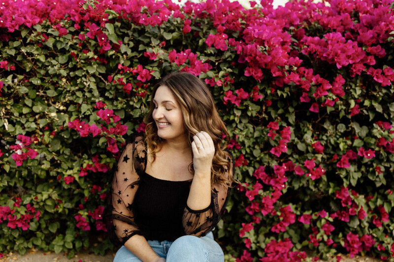 Portrait of Meg in front of pink flower wall