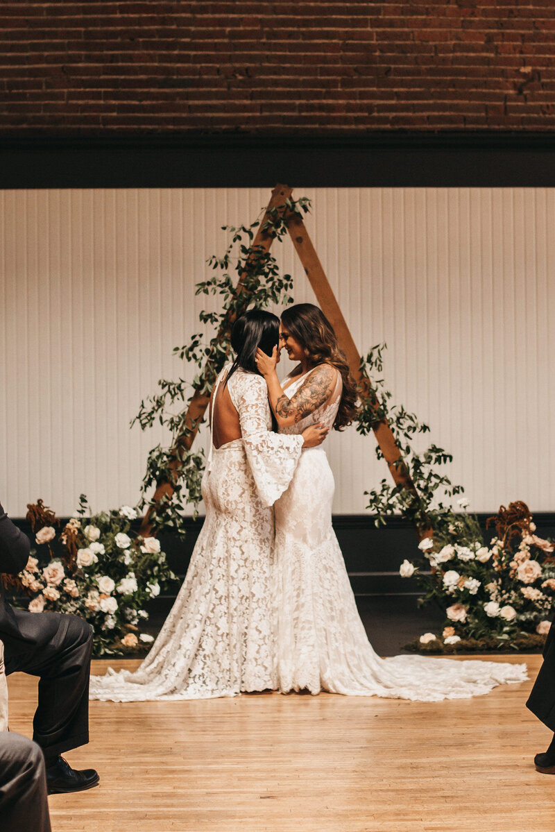 Same sex couple about to kiss on their wedding ceremony at The Evergreen