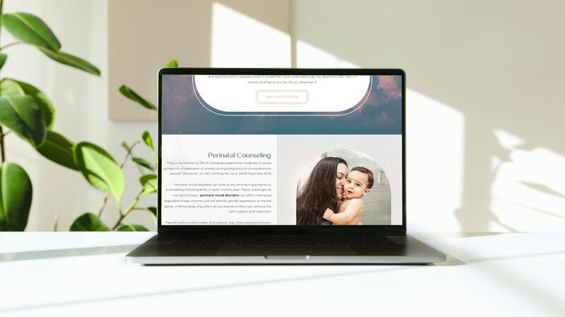 A sleek macbook pro sitting on a white desk showcasing the services page for a therapist website.