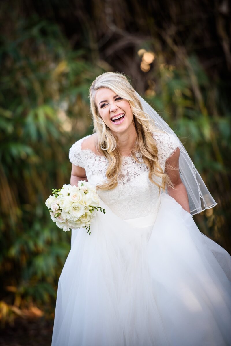 Bride laughing in New Orleans City Park