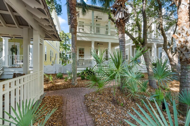 Paved path with tropical landscaping leading to the front entrance of Tangerine Dream in Florida