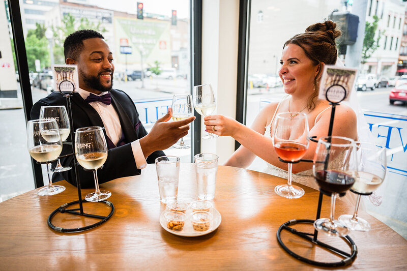 Two newlyweds on their elopement day visit Olde Salem Brewing Company and wait at the bar for their drinks.