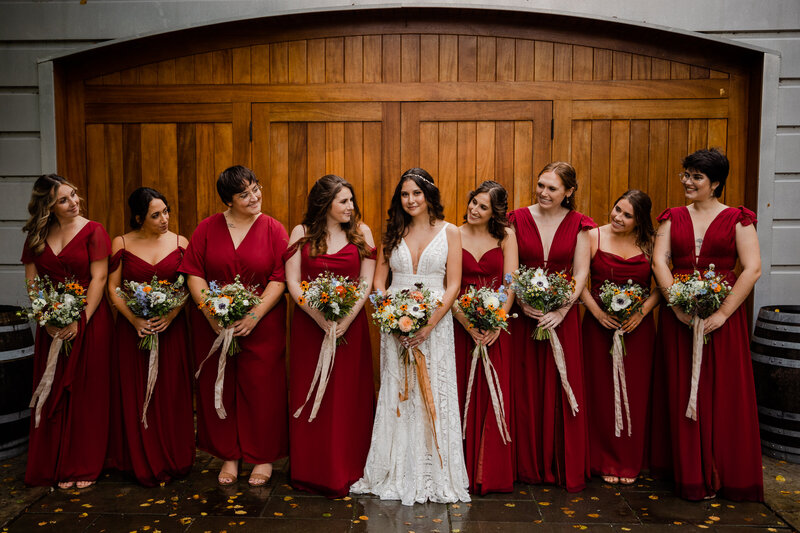 A Bridal party posing in front of Saltwater Farms Vineyard  In Connecticut.