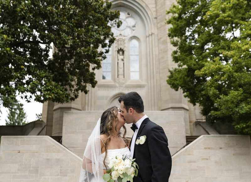 a bride and groom kissing on their wedding day