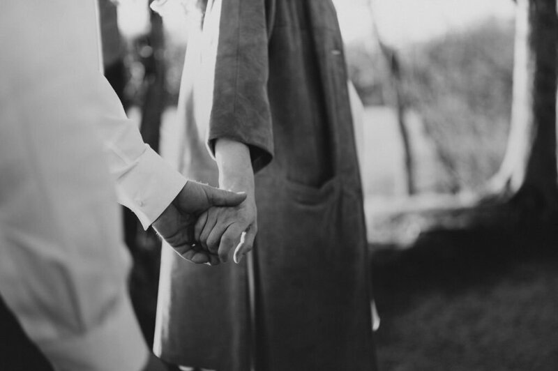 Couple holding hands outdoors during their romantic maternity session in Doylestown, Pennsylvania