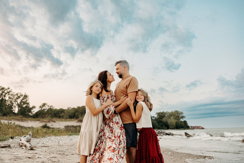 Family of five playing in a Wisconsin flower field at sunset.