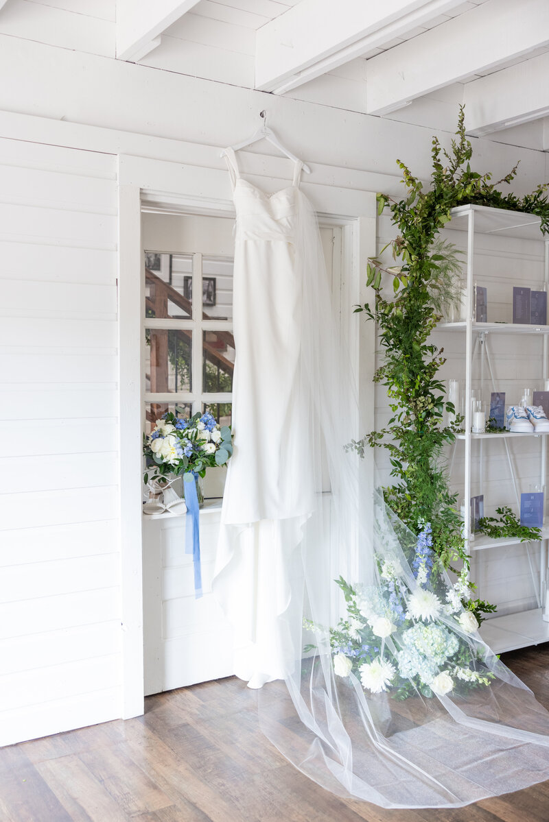Spring wedding at WinMock at Kinderton, designed by Charming Carolina — bride’s wedding dress hanging.