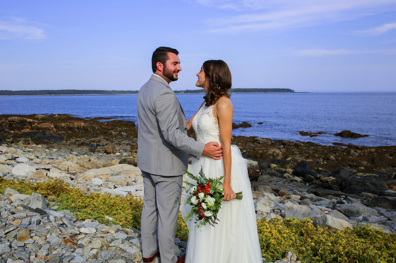 Bride and Groom standing together on beach looking at each other | Bar Harbor Wedding Photographer
