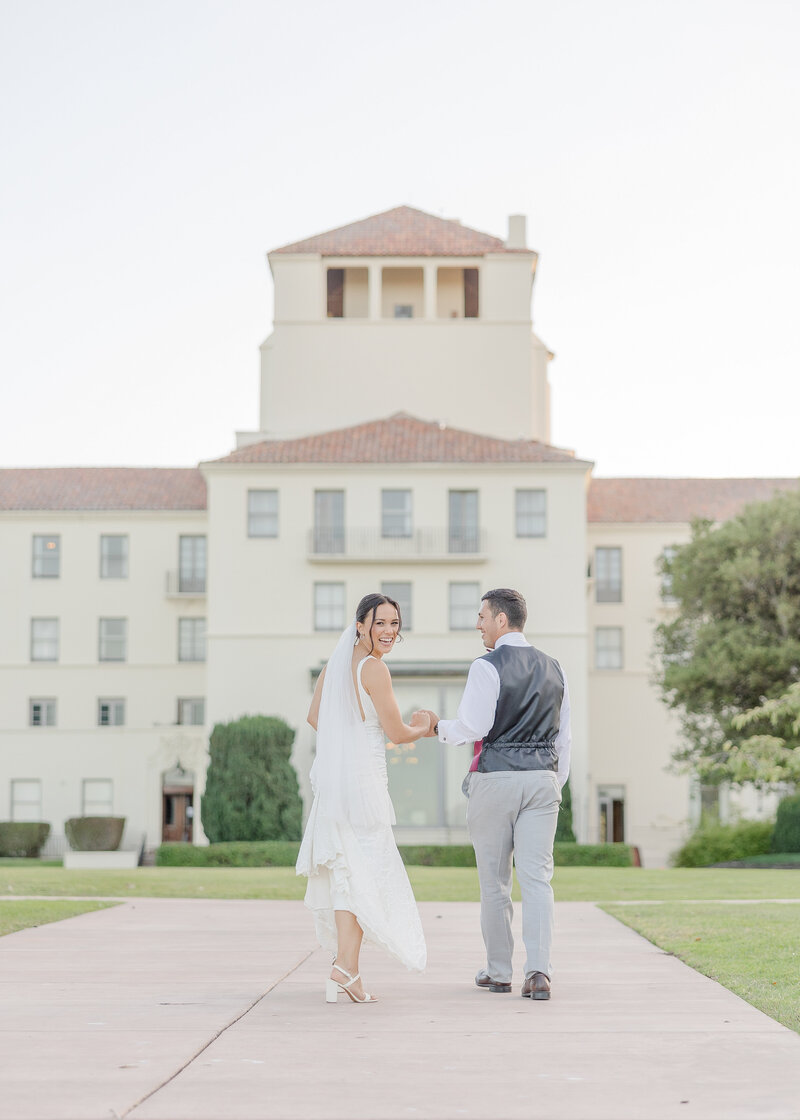 bride and groom walking towards their wedding venue