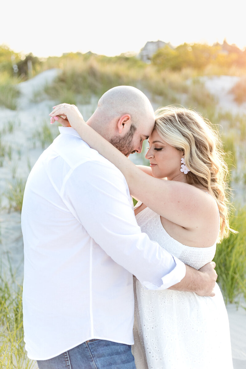 An engaged couple embrace on Wingearsheek beach