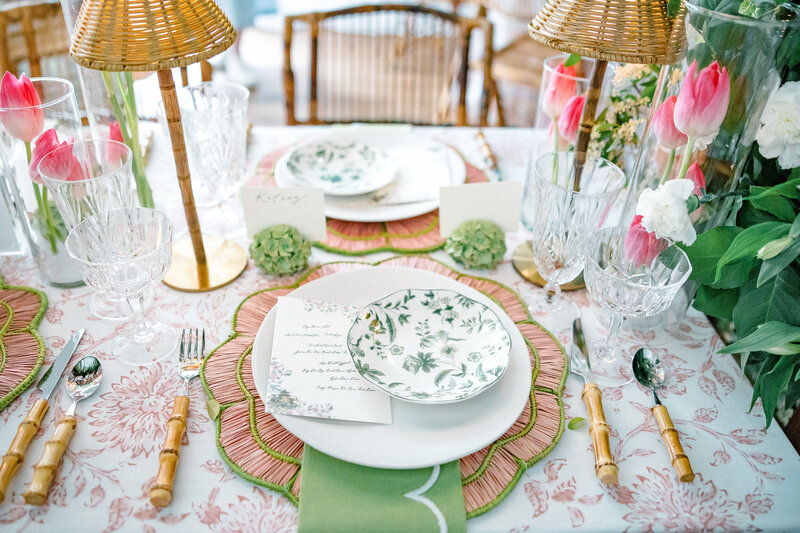 Pink straw chargers, green toile china, hand-written menu cards, bamboo handle silverware, tulip and hydrangea florals, and crystal goblets on pink toile table linens for a spring wedding in Atlanta Georgia | Atlanta wedding photographer Emily Nicole Photography