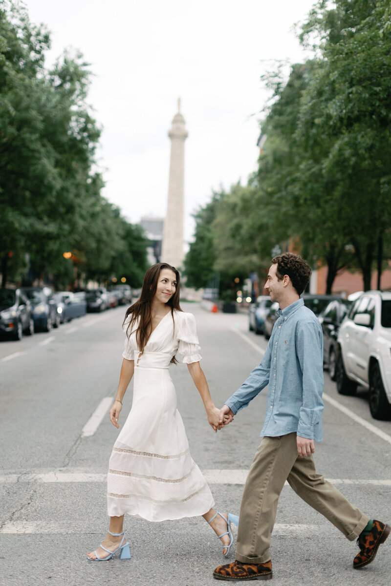 A couple walks around Mt Vernon in Baltimore Maryland