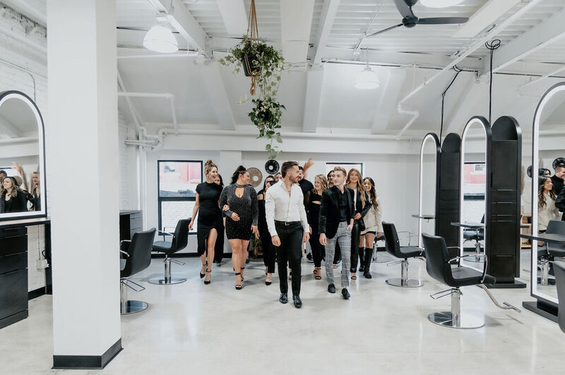 Salon Beau team walking together in their modern salon space, showcasing a welcoming and professional environment for clients seeking balayage, hair extensions, and lived-in color.