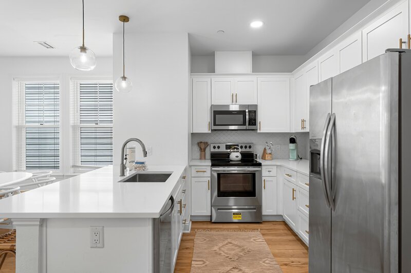 Fully equipped coastal kitchen with stainless steel appliances at Beach Cabana, a vibrant Panama City Beach vacation rental perfect for families and friend groups.
