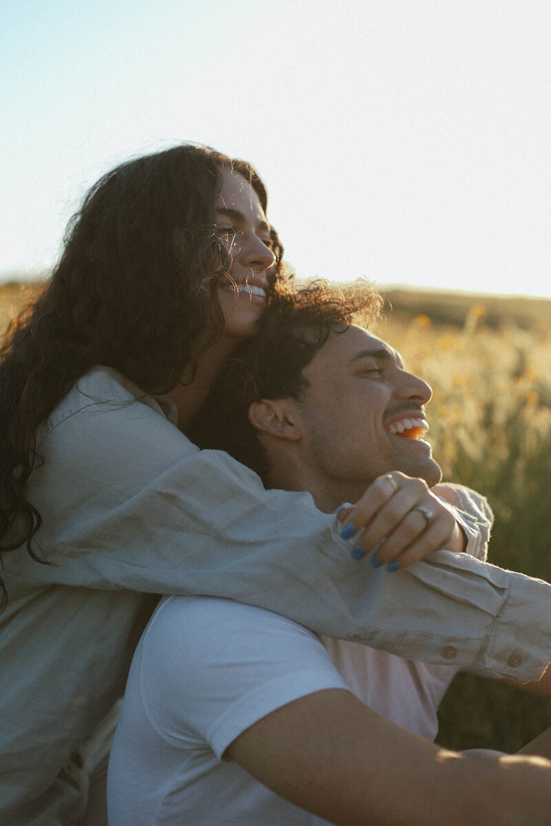 couple laughing together in field