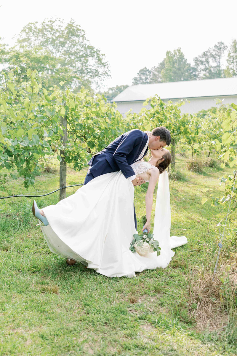 Couple  kissing amongst vineyards