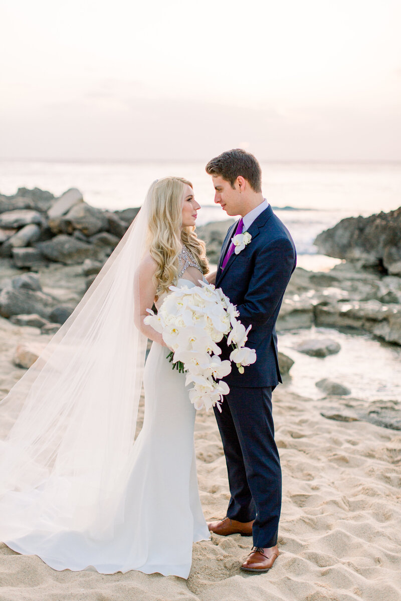 bride and groom on beach four seasons oahu hawaii
