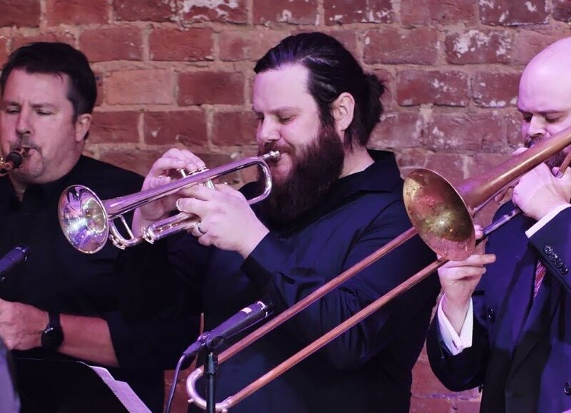 People playing brass instruments together 