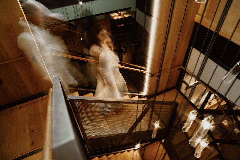 Newlyweds walk down the stairs at the Matheson in Healdsburg, CA to a private dinner after their all-day wine country adventure elopement