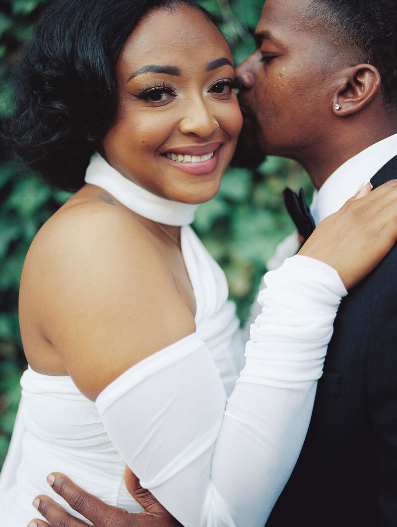 A couple stands on the steps of a Denver courthouse in an editorial engagement portrait.