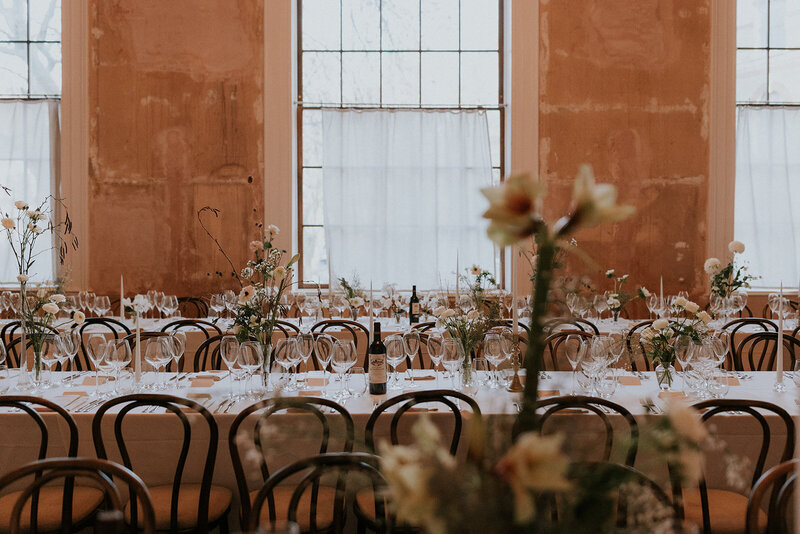 Elegant long tables with bistro chairs at Old Sessions House, planned by a London wedding planner.