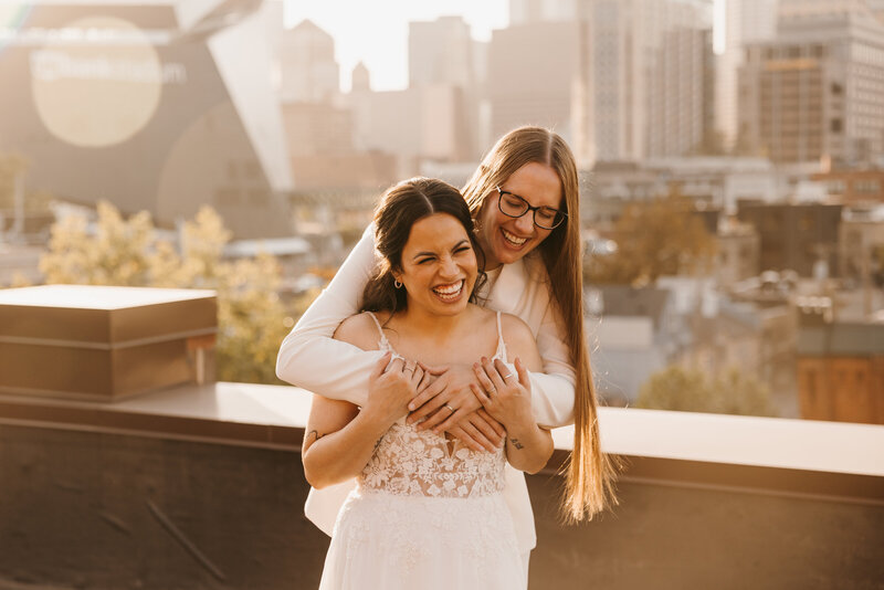 Bride wrapping her arms around her wife in Minneapolis