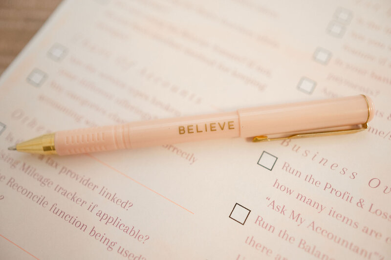 Pink pen laying on a print out of a questionnaire 