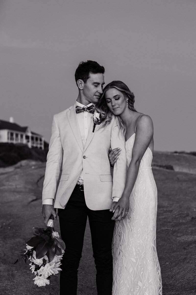 Sharing a close intimate moment at Victor Harbor cliffs after getting married.